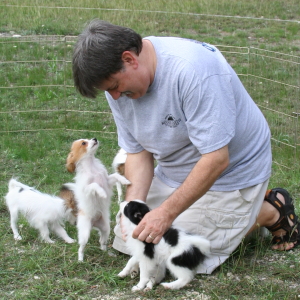 Danny in yard with puppies.